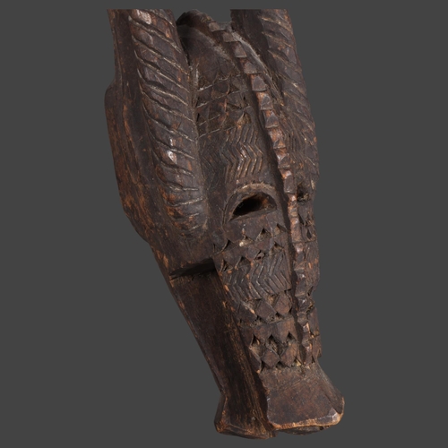 3098 - An African tribal carved wood Senufo Bobo zoomorphic helmet mask in the form of a horned creature, h... 