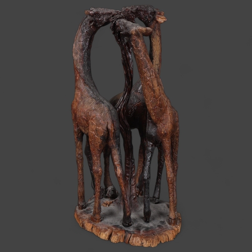 3162 - Natural History : A hardwood sculptural study of a tower of Giraffes, in eating poses, unsigned, hei... 