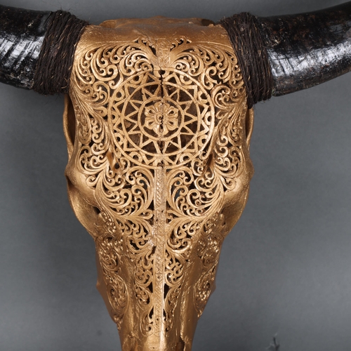 3166 - Taxidermy: Carved Water Buffalo Skull painted gold.
An impressive water buffalo cranium and horns. T... 