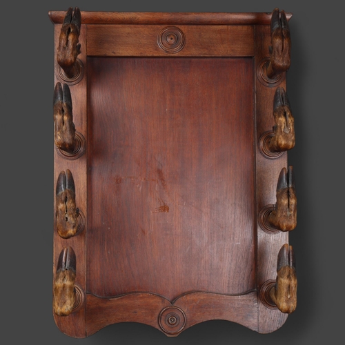 3175 - Taxidermy: Deer Hoof Coat / Gun Rack. 
A large oak panel with eight large red deer hoof slots, each ... 