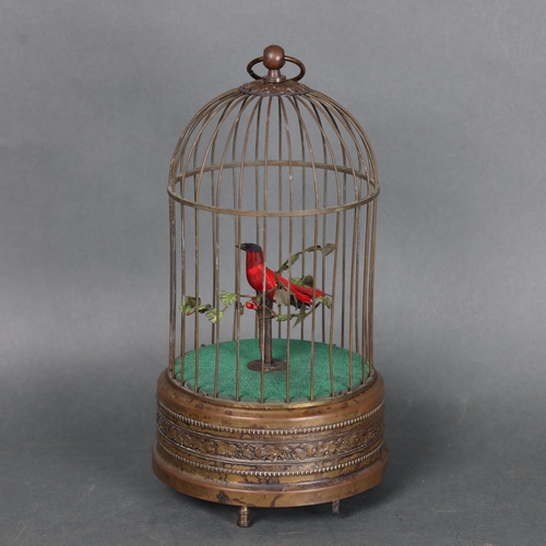 3218 - An Antique brass caged mechanical automaton with musical bird, height 28cm.