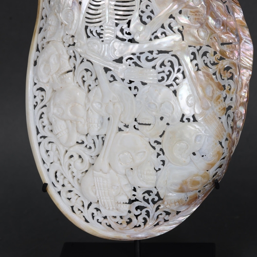 3221 - Natural History: Hand-carved River Mussel Mother of Pearl Shell with Skeleton and skulls
A polished,... 