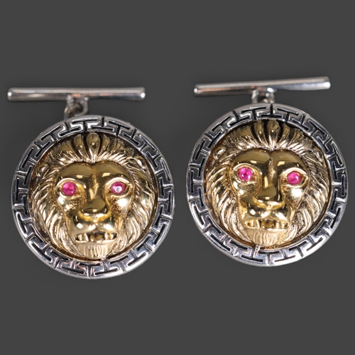 3251 - Jewellery: Silver Cufflinks in the form of  lion heads with pink sapphire eyes. Versace in style