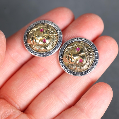 3251 - Jewellery: Silver Cufflinks in the form of  lion heads with pink sapphire eyes. Versace in style