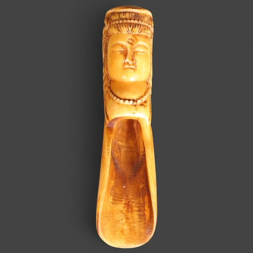 3265 - Chinese Bone Tea scoop 
The handle carved with a Buddha head, with bindi spot and wearing necklace.