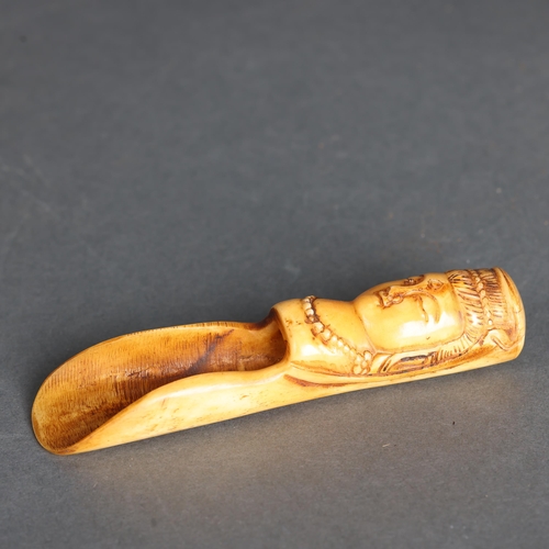 3265 - Chinese Bone Tea scoop 
The handle carved with a Buddha head, with bindi spot and wearing necklace.