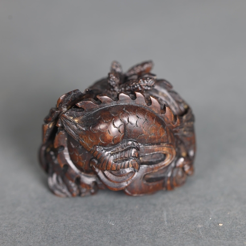 3274 - Netsuke: Japanese Dragon. Hand carved hardwood netsuke, with inlaid bone disc signature, of a Japane... 