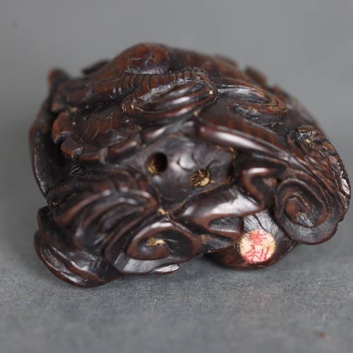 3274 - Netsuke: Japanese Dragon. Hand carved hardwood netsuke, with inlaid bone disc signature, of a Japane... 