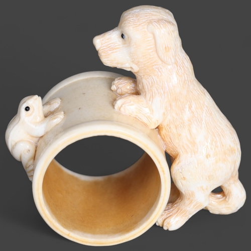 3292 - Curiosity/Macabre: Hand carved bone Napkin ring, with dog and frog detail.