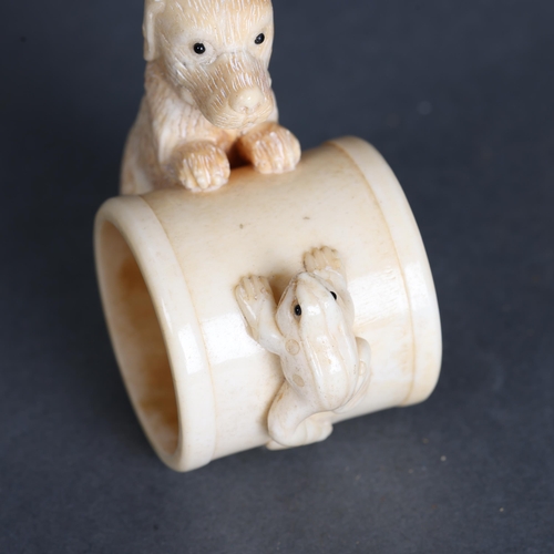 3292 - Curiosity/Macabre: Hand carved bone Napkin ring, with dog and frog detail.