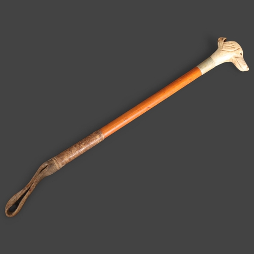 3310 - Natural History : An Antique bone dog's head whistle riding crop, length 17cm.