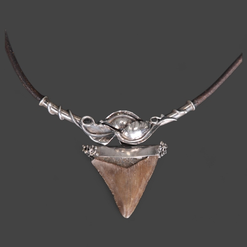 3333 - A leather and silver mounted necklace with Megalodon Sharks tooth pendant, tooth is 4cm in length.