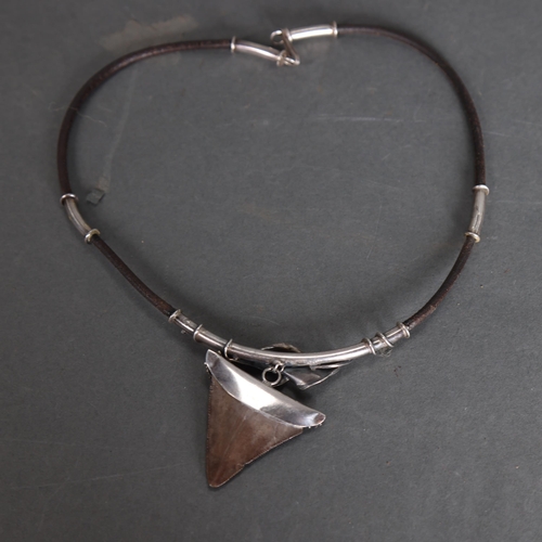 3333 - A leather and silver mounted necklace with Megalodon Sharks tooth pendant, tooth is 4cm in length.