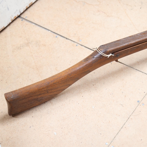 3384 - An Antique apprentice piece wooden crossbow, length 104cm.