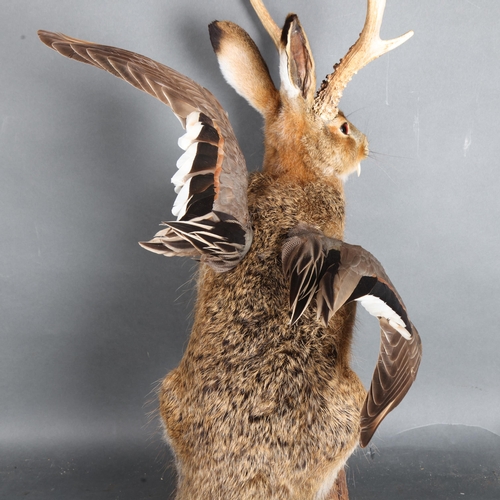 3401 - Taxidermy: “Wolpertinger”. Full mount, with one paw raised, on log base. A particularly fine example... 