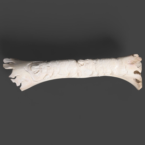 3409 - Natural History : Carved Buffalo bone depicting hippos.
The bone retaining original shape but decora... 