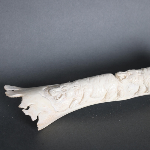 3409 - Natural History : Carved Buffalo bone depicting hippos.
The bone retaining original shape but decora... 