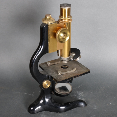 3438 - E. Leitz Wetzlar, an early 20th Century brass and oxidised monocular microscope, number 134099, in o... 