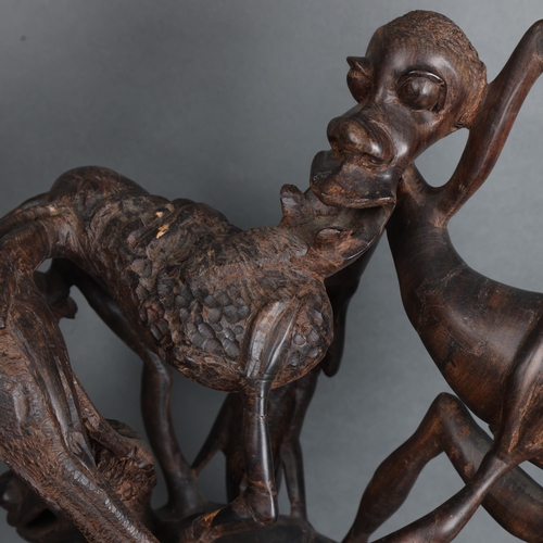 3465 - A large mid-century African Makonde Shetani ironwood sculpture featuring intertwined creatures, heig... 