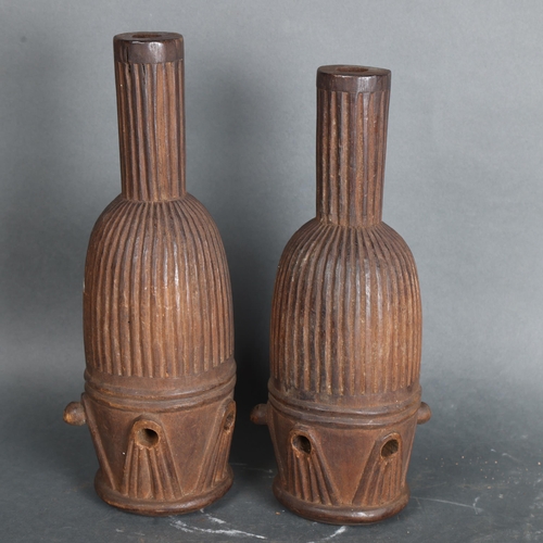 3469 - A pair of African tribal ceremonial carved wood representations of drums, indistinct inscriptions to... 