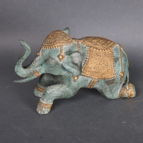 3474 - Bronze Elephant. Modelled in a kneeling position with decorative headdress and saddle. Made from bro... 