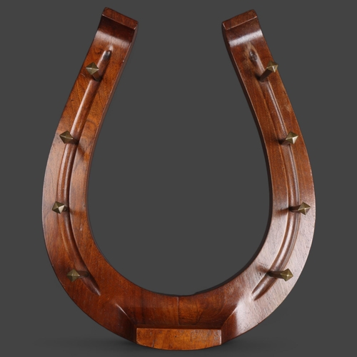 3503 - A mahogany horseshoe whip rack, overall length 47cm.