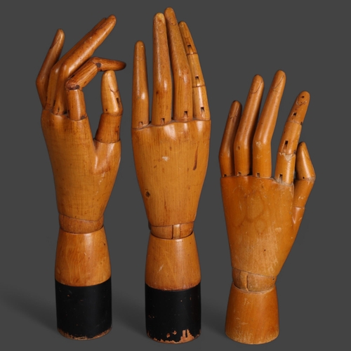 3524 - A group of three similar vintage carved wood articulated artist's hands, largest, height 30cm, (3)