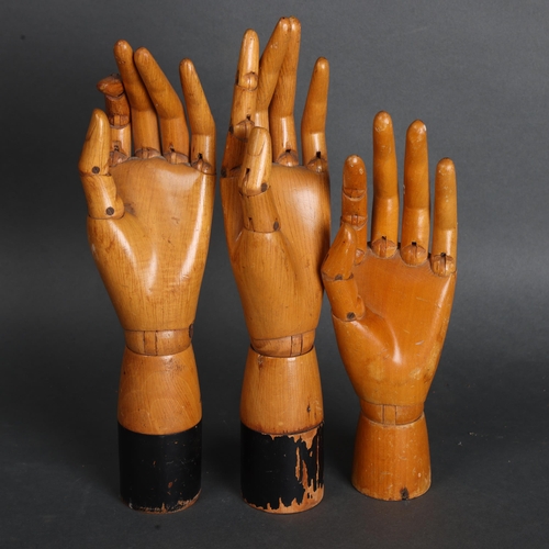 3524 - A group of three similar vintage carved wood articulated artist's hands, largest, height 30cm, (3)