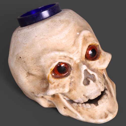 3546 - Curiosity/Macabre: An Antique porcelain ink-well in the form of a skull with glass eyes, height 7cm.