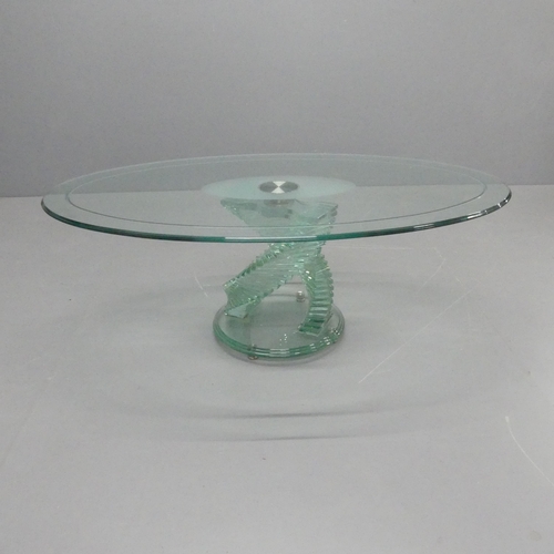 2343 - A contemporary oval glass topped coffee table on stepped spiral base, in the manner of Danny Lane. 1... 