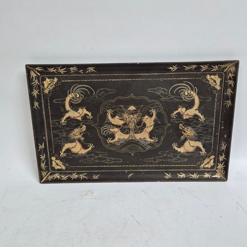 229 - A rectangular black lacquered serving tray, gilded dragon decoration, 53cm x 33cm