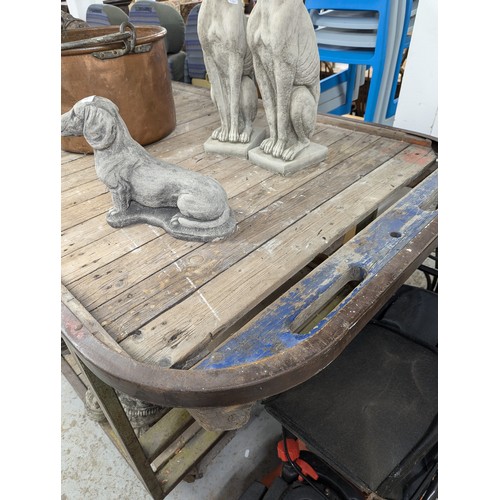 2867 - A very large two-tier industrial work bench / shop display table, with cast iron frame, pine slats a... 