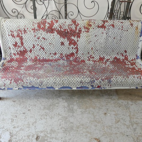 2989 - A vintage weathered and white painted metal British Rail station bench. Overall 183x75x80cm.