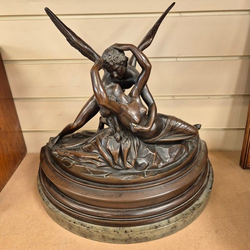 86 - A cast-bronze study of Cupid and Psyche, mounted on a green marble base of demi-lune form, H40cm