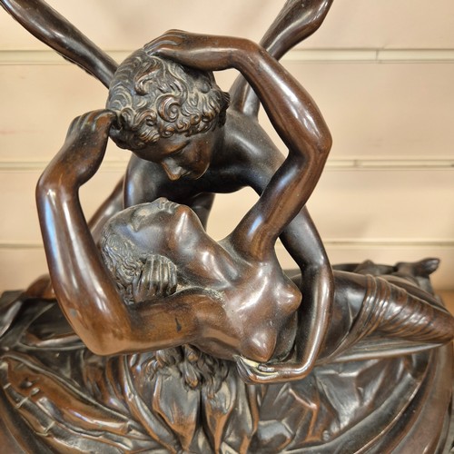 86 - A cast-bronze study of Cupid and Psyche, mounted on a green marble base of demi-lune form, H40cm