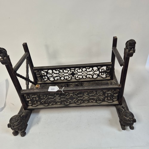 225 - An Oriental carved and pierced hardwood stand, raised on dog of fo supports, W55cm