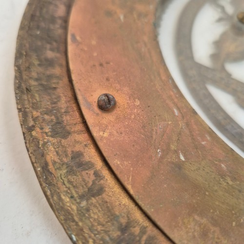 247 - An Antique circular brass and glass plaque, with applied swag and rose decoration and Grecian figure... 