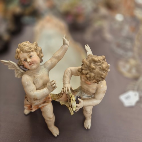 386 - A large quantity of 19th century Continental porcelain ware, various cherub decoration, and includin... 