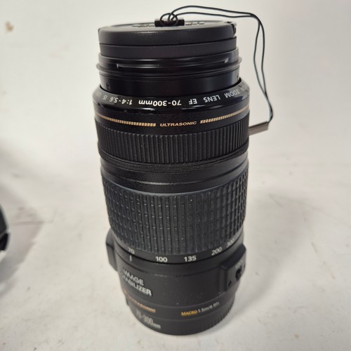 355 - A Canon EO5500D, and associated Canon zoom lenses, and a Sigma zoom lens 28-200mm, in original packa... 