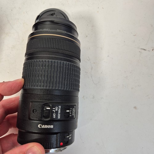 355 - A Canon EO5500D, and associated Canon zoom lenses, and a Sigma zoom lens 28-200mm, in original packa... 