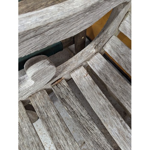 2856 - P J Bridgman & Co. Ltd, Enfield - A weathered teak garden bench. Overall 150x83x60cm.... 