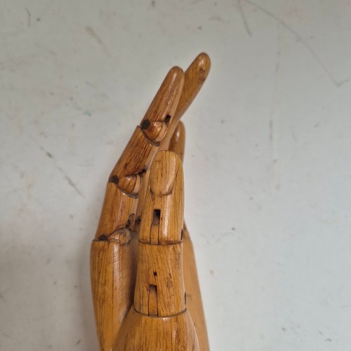 3524 - A group of three similar vintage carved wood articulated artist's hands, largest, height 30cm, (3)