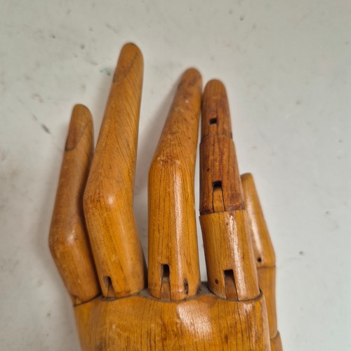 3524 - A group of three similar vintage carved wood articulated artist's hands, largest, height 30cm, (3)