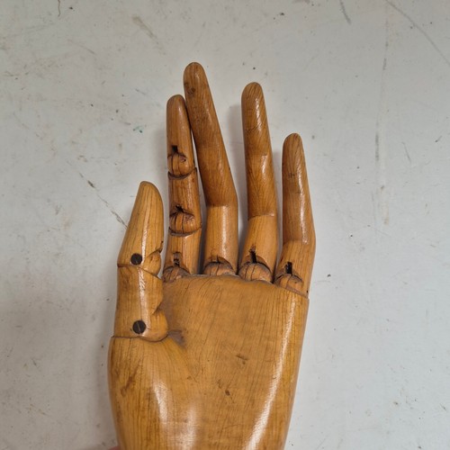 3524 - A group of three similar vintage carved wood articulated artist's hands, largest, height 30cm, (3)