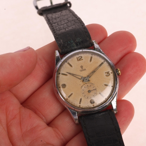 1011 - TUDOR - a Vintage stainless steel mechanical wristwatch, ref. 709, circa 1950s, silvered dial with a... 