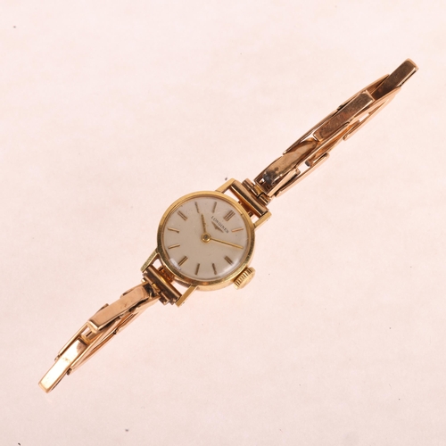 1039 - LONGINES - a lady's 18ct gold mechanical bracelet watch, circa 1960s, silvered dial with applied gil... 