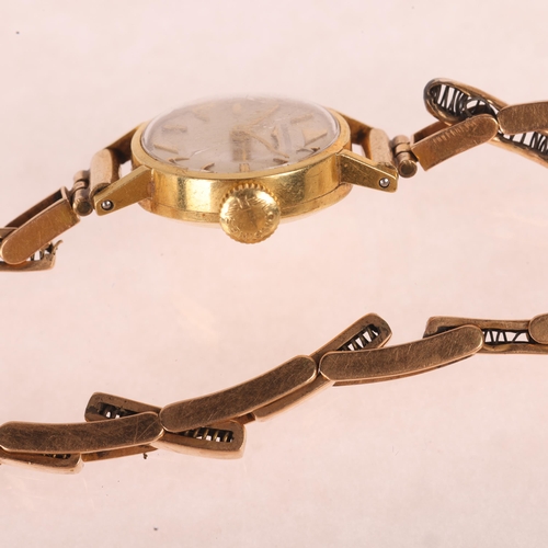 1039 - LONGINES - a lady's 18ct gold mechanical bracelet watch, circa 1960s, silvered dial with applied gil... 