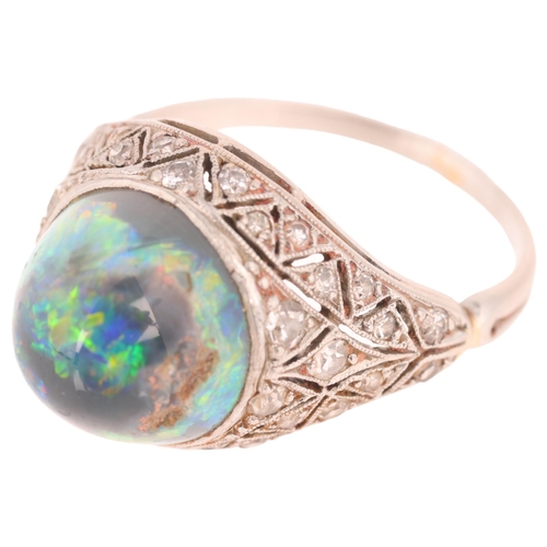 1102 - An Art Deco platinum black opal and diamond ring, centrally set with round high cabochon black opal ... 