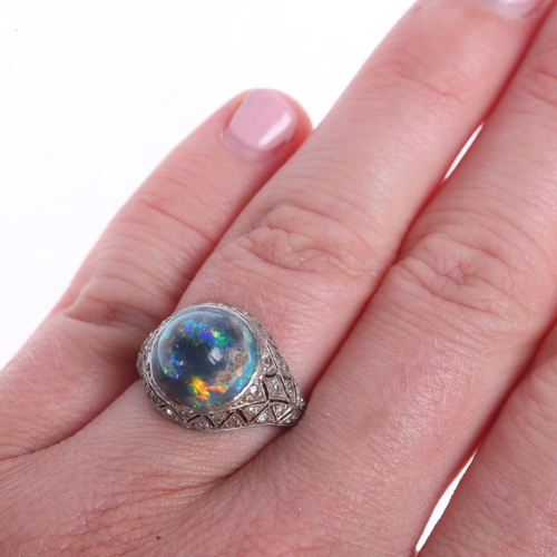 1102 - An Art Deco platinum black opal and diamond ring, centrally set with round high cabochon black opal ... 