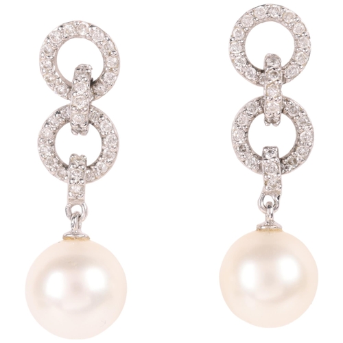 1105 - A pair of 18ct gold whole pearl and diamond drop stud earrings, each set with 7.7mm pearl suspended ... 